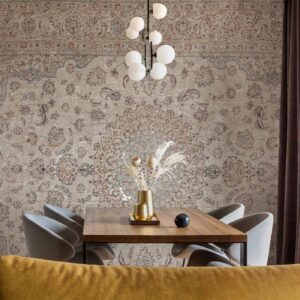 Fotobehang - Sand carpet - worn Persian carpet with rich decorative motifs